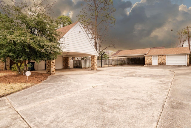 view of front of property with driveway and fence