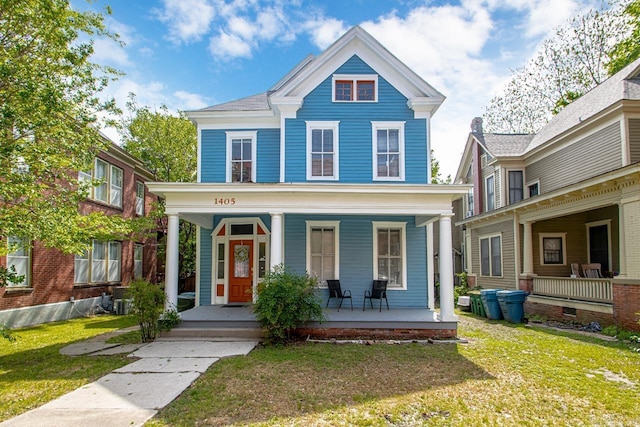 view of front of property with a porch and a front yard