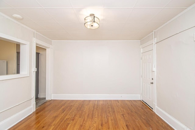 spare room featuring wood finished floors and baseboards