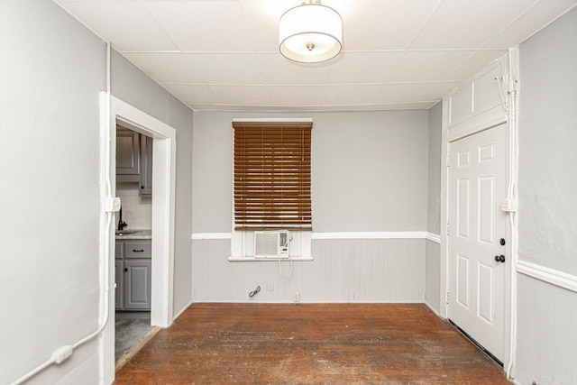 empty room featuring hardwood / wood-style floors and wainscoting