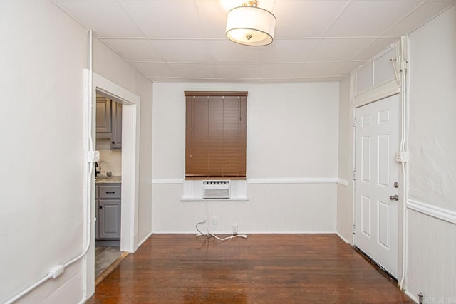 spare room featuring wainscoting and wood finished floors