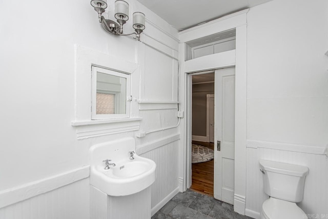 half bathroom with a decorative wall and toilet