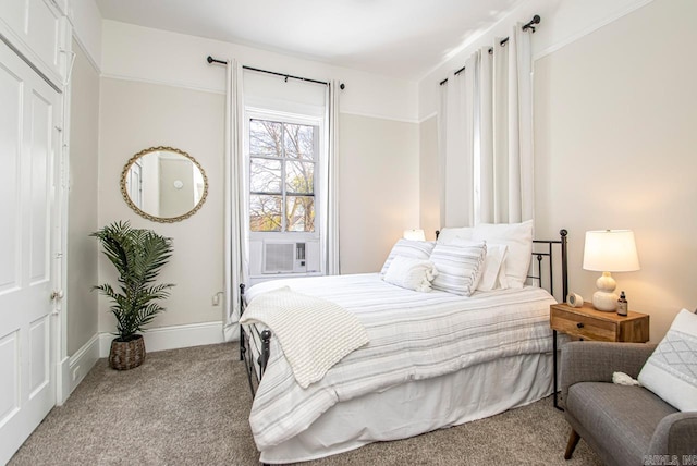 bedroom with cooling unit, baseboards, and carpet