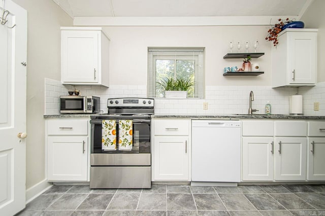 kitchen with backsplash, light stone counters, appliances with stainless steel finishes, white cabinets, and open shelves