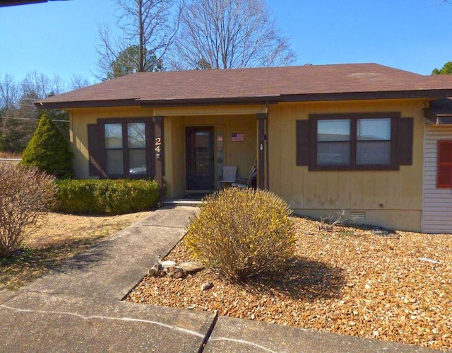 view of front of home with crawl space and a shingled roof