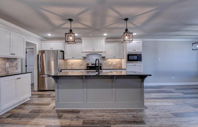 kitchen with built in microwave, ornamental molding, freestanding refrigerator, and a sink