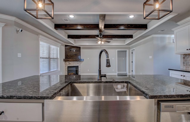 kitchen with visible vents, beamed ceiling, open floor plan, a glass covered fireplace, and dishwasher