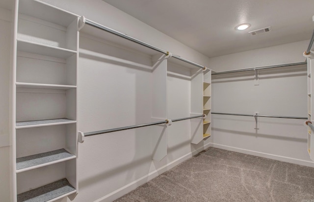 spacious closet featuring visible vents and carpet