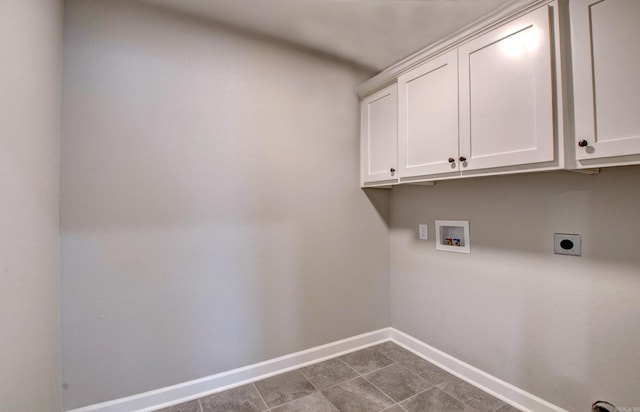 laundry room with baseboards, hookup for a washing machine, cabinet space, hookup for an electric dryer, and dark tile patterned flooring