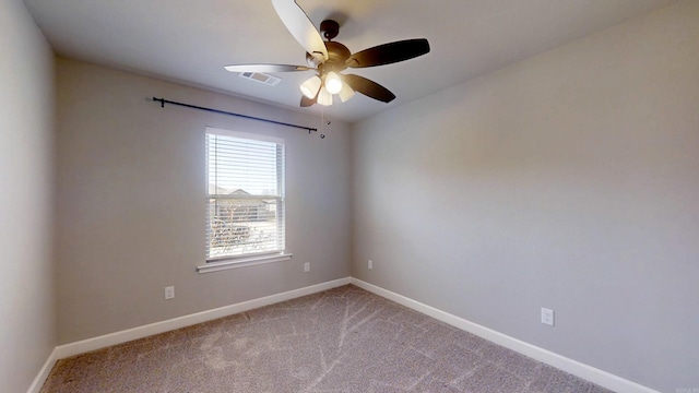 empty room with a ceiling fan, visible vents, carpet, and baseboards