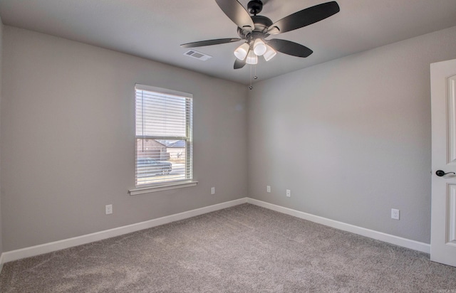 empty room with visible vents, ceiling fan, baseboards, and carpet floors