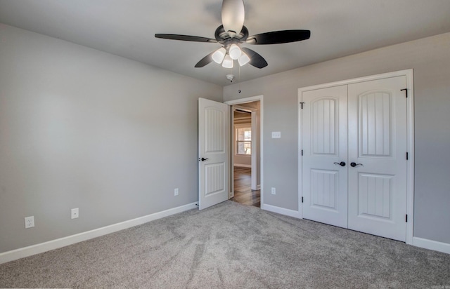 unfurnished bedroom featuring a closet, carpet flooring, ceiling fan, and baseboards