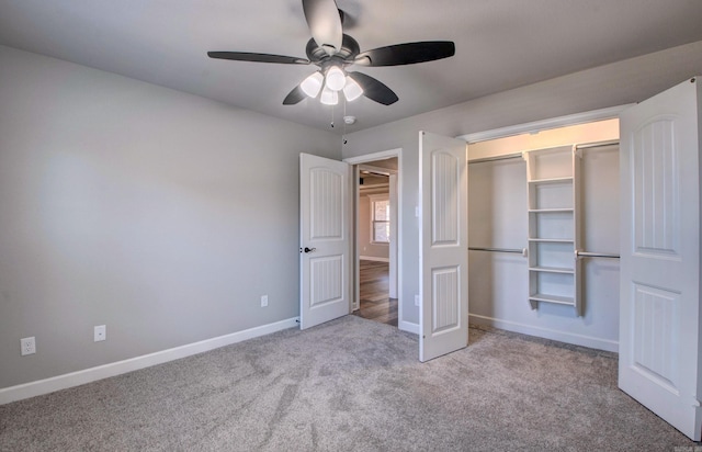 unfurnished bedroom featuring carpet, baseboards, a closet, and ceiling fan