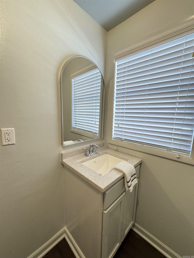 bathroom with baseboards and vanity