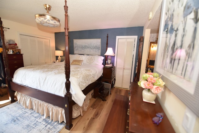 bedroom with wood finished floors and a textured ceiling