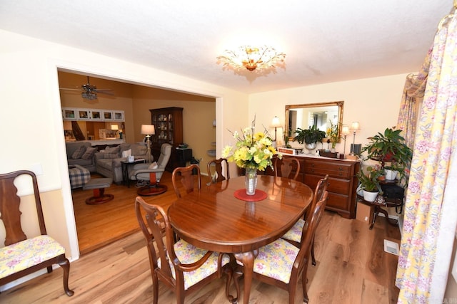 dining room with visible vents, light wood finished floors, and ceiling fan