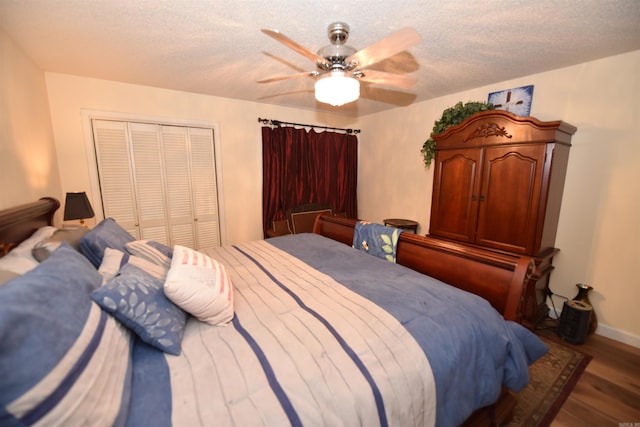 bedroom featuring baseboards, ceiling fan, wood finished floors, a closet, and a textured ceiling