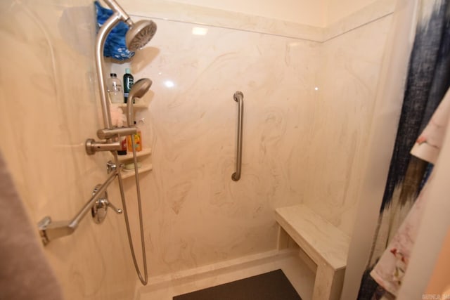 bathroom featuring a marble finish shower