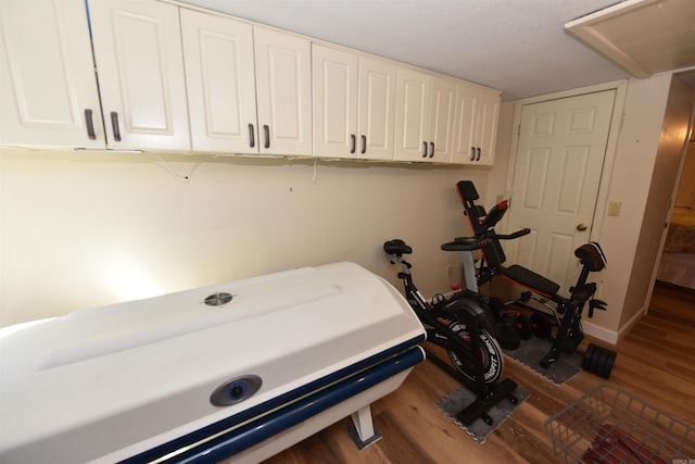 bedroom featuring baseboards and wood finished floors