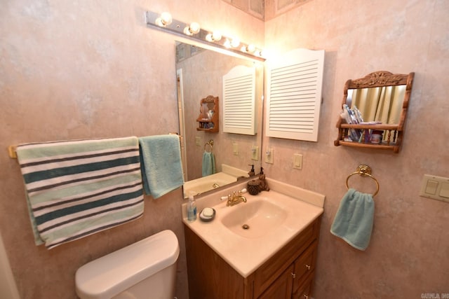 bathroom with toilet and vanity