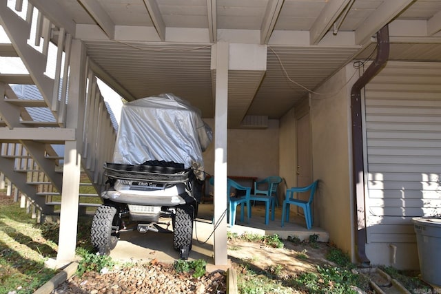 view of patio / terrace with a carport and covered porch