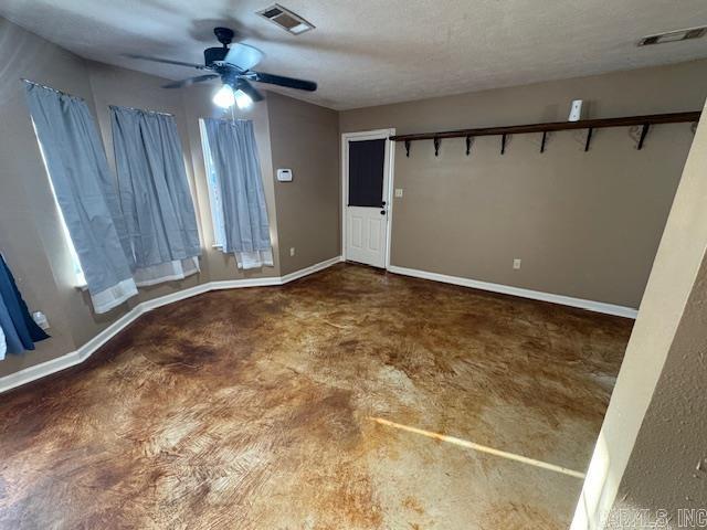 interior space featuring a ceiling fan, baseboards, and visible vents