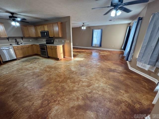 kitchen featuring a sink, open floor plan, stainless steel appliances, light countertops, and baseboards