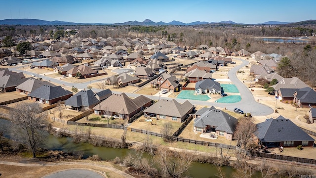 drone / aerial view with a residential view and a water and mountain view