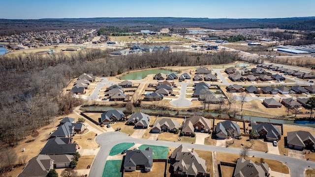 drone / aerial view featuring a residential view and a water view