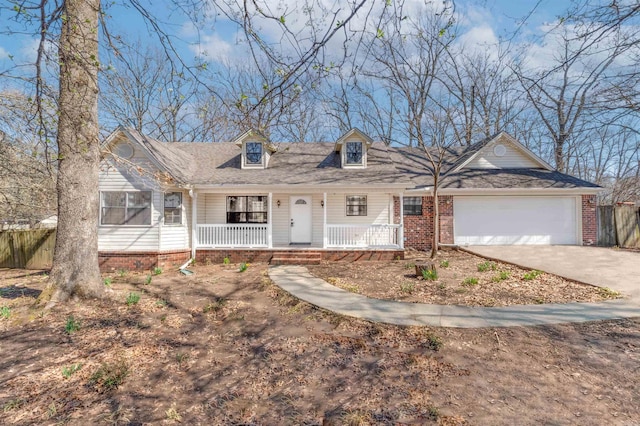 cape cod house with brick siding, fence, concrete driveway, covered porch, and a garage