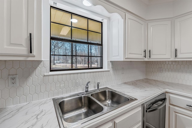 kitchen featuring dishwasher, backsplash, white cabinetry, and a sink