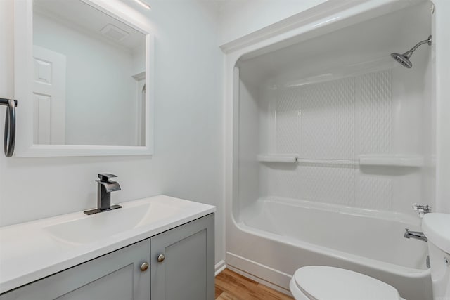 bathroom featuring visible vents, toilet, bathing tub / shower combination, wood finished floors, and vanity