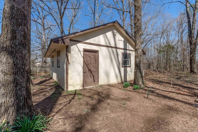 view of outbuilding with fence