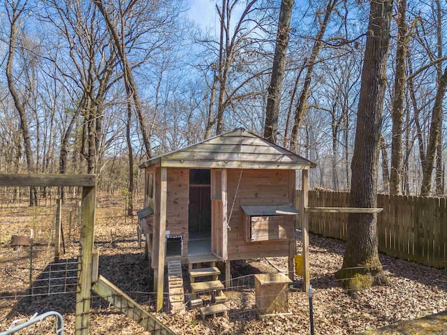 view of poultry coop featuring fence