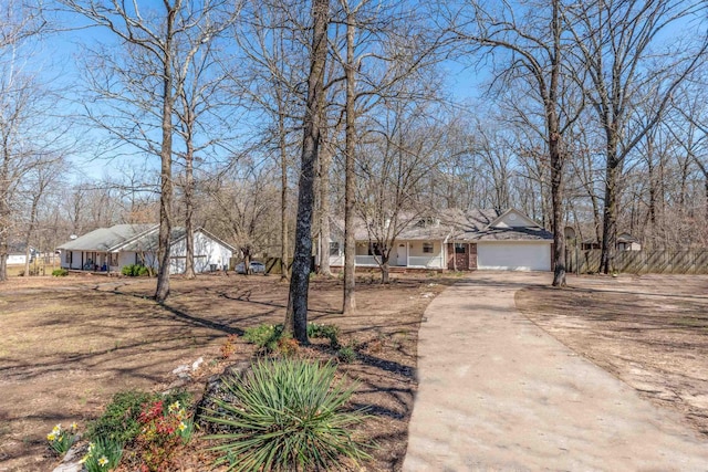 ranch-style house with concrete driveway and an attached garage