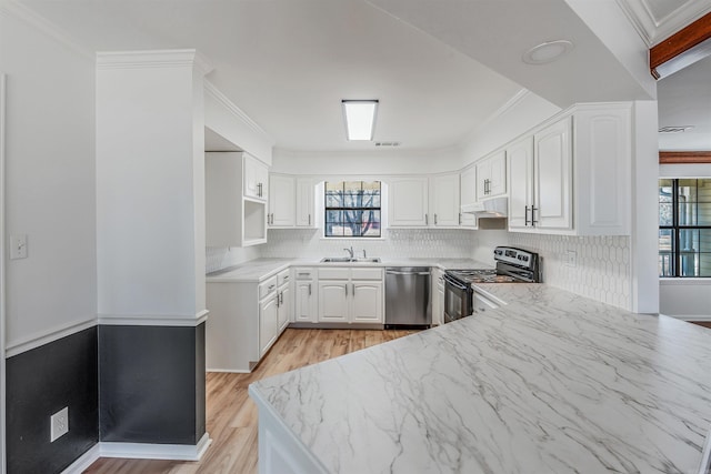 kitchen with backsplash, under cabinet range hood, stainless steel appliances, white cabinetry, and a sink