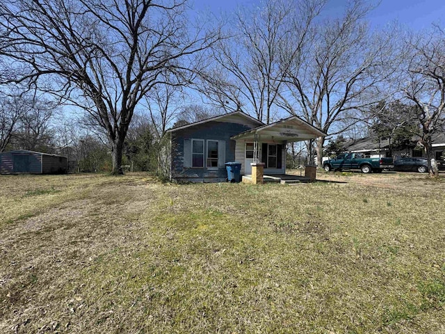 view of front of property with covered porch and an outdoor structure