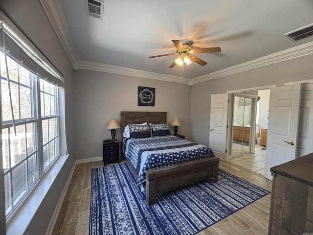 bedroom featuring visible vents, baseboards, wood finished floors, and ornamental molding