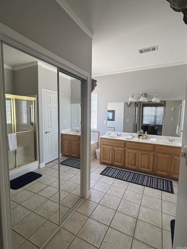 bathroom featuring a sink, visible vents, and tile patterned flooring