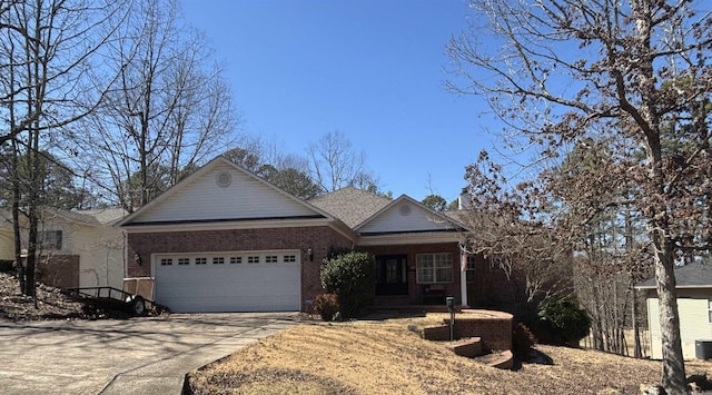 ranch-style house with driveway, brick siding, and an attached garage