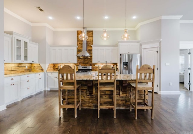 dining room featuring visible vents, dark wood finished floors, a high ceiling, crown molding, and baseboards