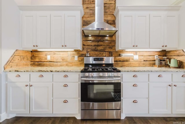 kitchen featuring gas range, ventilation hood, light stone countertops, and white cabinets