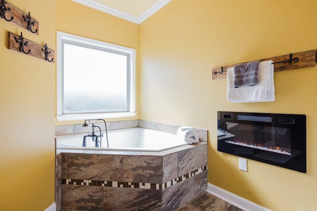 full bathroom with baseboards, a garden tub, a glass covered fireplace, and crown molding