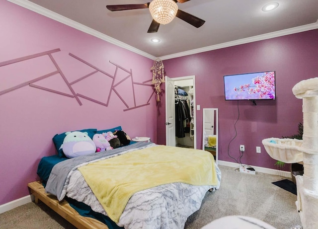 bedroom featuring a spacious closet, crown molding, and carpet