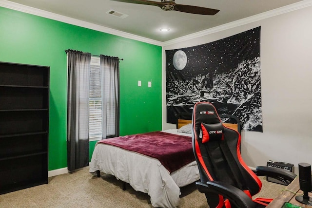 carpeted bedroom featuring visible vents, baseboards, a ceiling fan, and crown molding