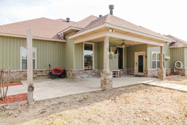 rear view of property with a patio area, ceiling fan, and a shingled roof