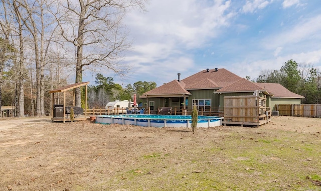 view of swimming pool featuring a fenced in pool, fence, and a wooden deck