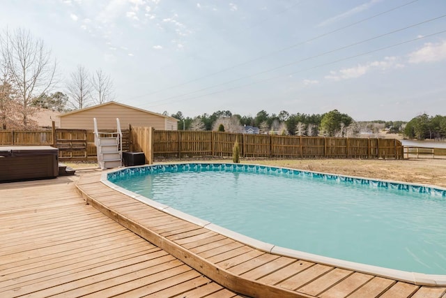 view of pool with a deck, a fenced backyard, a fenced in pool, and a hot tub