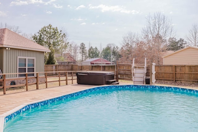 view of pool featuring a fenced in pool, a deck, a fenced backyard, and a hot tub