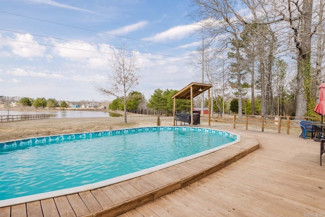 outdoor pool with a wooden deck